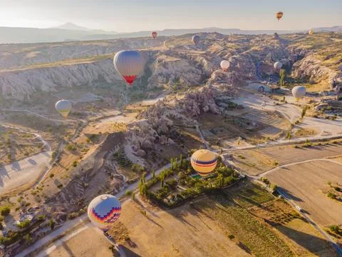 Colorful hot air balloons flying over at fairy chimneys valley in Nevsehir Stock Photos