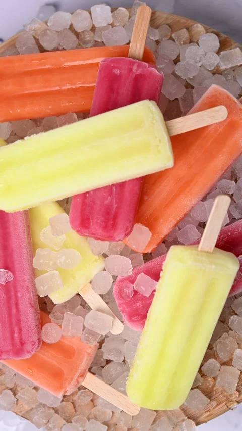 Colorful ice pops rotating on surface close up loop Stock Footage 331987283