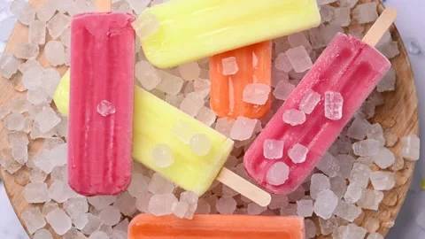 Colorful ice pops rotating on surface close up loop Stock Footage 331987300