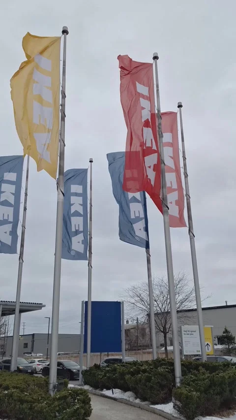Colorful Ikea flags waving in the wind outside a store Vídeo Stock 326168440