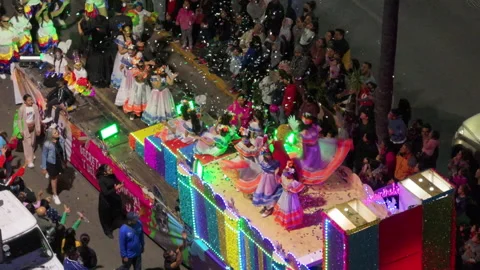 Colorful illuminated parade float with dancers in traditional Mexican dresses. Stock Footage 337911702
