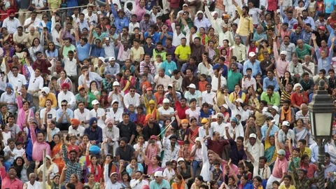 Colorful Indian crowd stadium audience cheer and raise hands, Wagah border Stock Footage