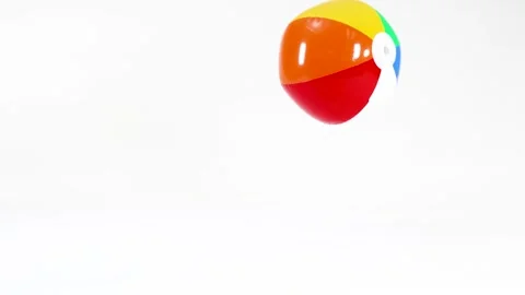 Colorful Inflatable Beach Ball Bouncing and Rolling on White Background Stock Footage 332967473