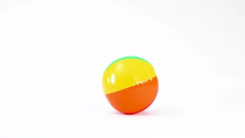 Colorful Inflatable Beach Ball Bouncing and Rolling on White Background Stock Footage 332978376