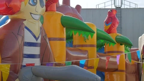 Colorful Inflatable Bouncy Castle with Flags at Outdoor Event Stock Footage 342222346
