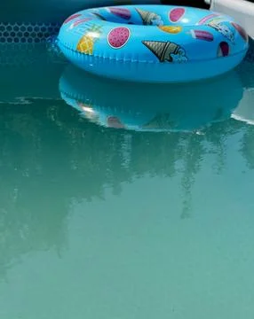 Colorful Inflatable Ring Floating in Pool Stock Photos