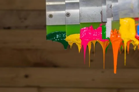 Colorful ink flow down from printer handle Stock Photos