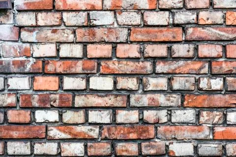 Colorful irregular brick wall texture or background. Stock Photos