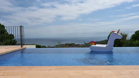 Colorful kinder inflatable ring in swims an empty outdoor pool Vídeos de archivo 248319953