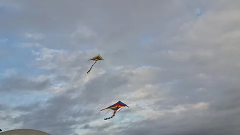 Colorful kite flying in a cloudy sky. Stock Footage 332280740