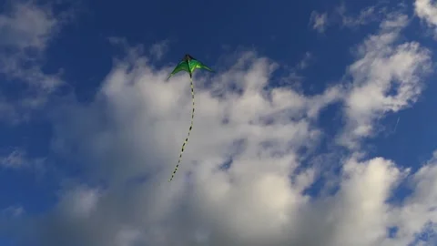 A colorful kite soaring across a deep blue sky on a windy day,outdoor recreation Stock Footage 330601074