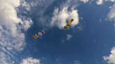 Colorful kites shaped like rectangle soaring high in blue sky clouds. Stock Footage 303963535