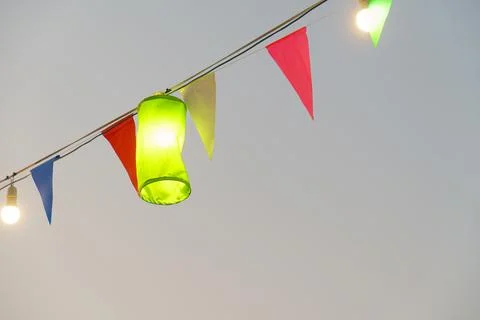 Colorful lanterns and flags create festive atmosphere outdoors Stock Photos