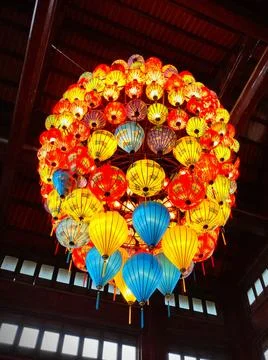 Colorful lanterns hang from the ceiling in a large building during a festiv.. Stock Photos