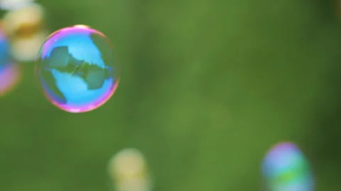 Colorful Large Soap Bubbles in Slow Motion. Holiday Background Birthday Close-up Stock Footage 247728243