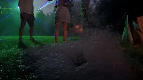 Colorful laser lights and bubbles create vibrant atmosphere at outdoor party Stock Footage 338266012