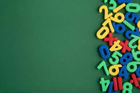 Colorful learning numbers and math symbols on green background Stock Photos