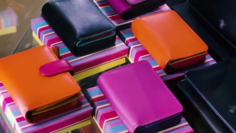 Colorful Leather Wallets Display on Striped Boxes in Accessories Store Showcase Stock Footage 333018060