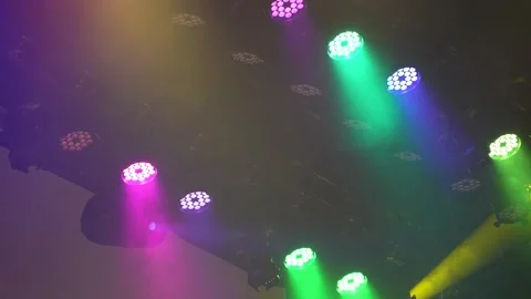Colorful LED stage lights changing colors rapidly in smoke Stock Footage 346360033