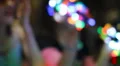 Colorful LED throwies in hands - handful pumping in soft focus HD Footage