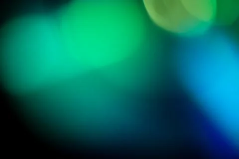 Colorful light defocused creating soft green, yellow, and blue bokeh circle.. Foto stock