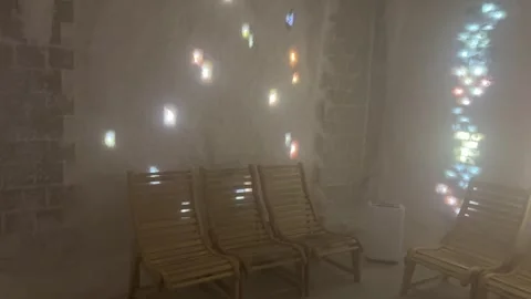 Colorful light reflections moving inside a salt cave halotherapy room Stock Footage 318284293