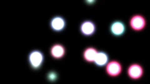 Colorful light spots move across a dark background in a Stock Footage 338241914