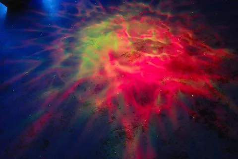 Colorful lights create patterns on the floor in a dark space Stock Photos