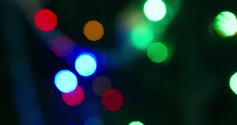 Colorful lights flicker in the dark. Close-up. Defocus Stock Footage 146770772