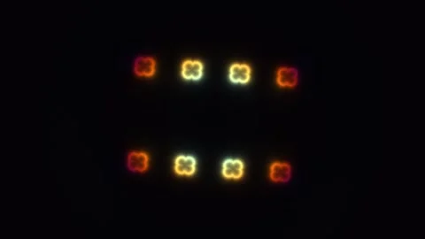 Colorful lights shine in a pattern against a dark Stock Footage 338179010