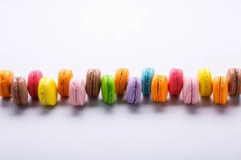 Colorful macarons on gray background. Macaron or Macaroon is sweet meringue-b Stock Photos