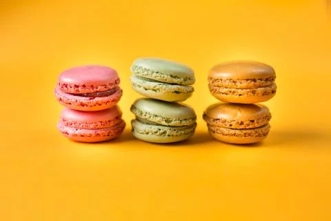Colorful macarons on yellow background Stock Photos