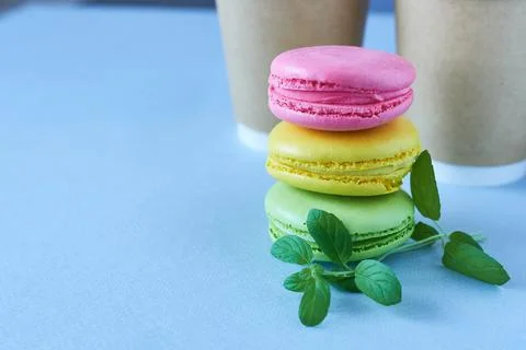 Colorful macaroons on blue background. Macaroon with mint. Stock Photos