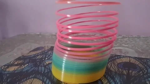 Colorful magic rainbow spring toy stretching dynamically with vibrant coils, Stock Footage 334554517