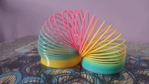 Colorful magic rainbow spring toy stretching dynamically with vibrant coils, Stock Footage 334554642