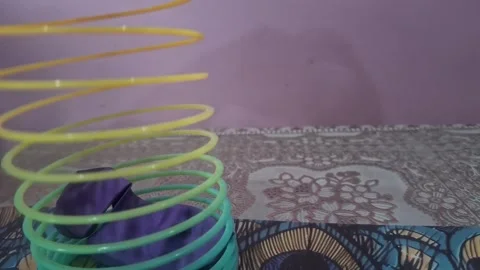 Colorful magic rainbow spring toy stretching dynamically with vibrant coils, Stock Footage 334555003