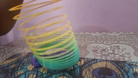 Colorful magic rainbow spring toy stretching dynamically with vibrant coils, Stock Footage 334555004