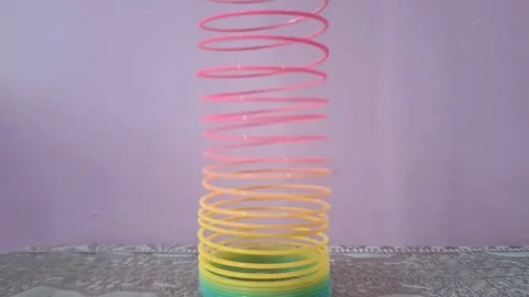 Colorful magic rainbow spring toy stretching dynamically with vibrant coils, Stock Footage 334555102