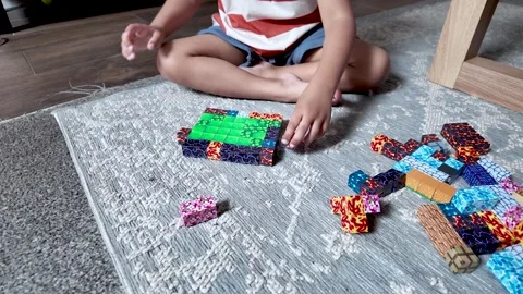 Colorful Magnetic Block Pattern on Rug with South Asian Boy’s Hands Stock Footage 338026257