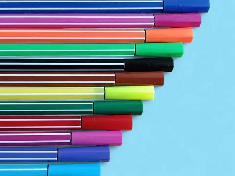 Colorful Marker Pens Corner Arrangement on Blue Background with Copy Space Stock Photos