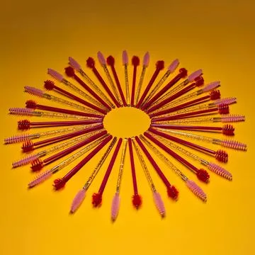 Colorful matches arranged in a circular pattern on yellow surface Stock Photos