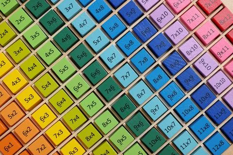 Colorful math game kit with arithmetical tasks as background, top view Stock Photos