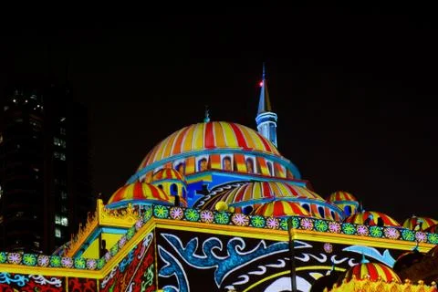 Colorful Middle Eastern patterns displayed on a mosque - Sharjah lights festival Stock Photos