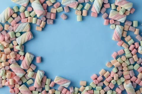 Colorful mini marshmallows background frame. Copy space for text. Stock Photos