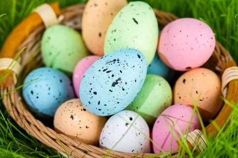 Colorful multi-colored Easter eggs lie on the green grass. Painted eggs in th Stock Photos