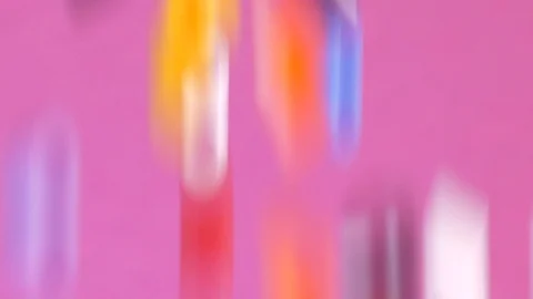 Colorful multicolor objects falling down on pink background Video stock 120819796