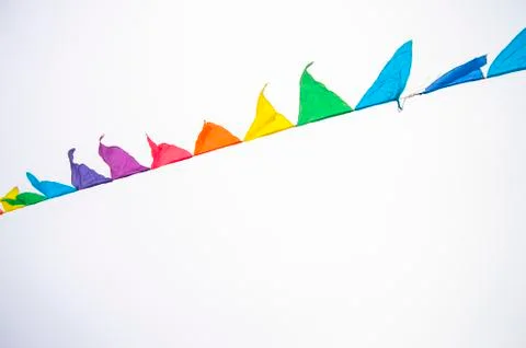Colorful multicolored triangular flags, isolated on a white background, hang  写真素材