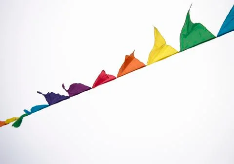 Colorful multicolored triangular flags, isolated on a white background, hang  스톡 사진