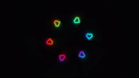 Colorful neon hearts in a circular pattern on black Stock Footage 338229233