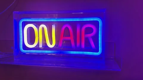 Colorful neon light featuring the text 'On Air' indicating online in tv, radi Video stock 336078373